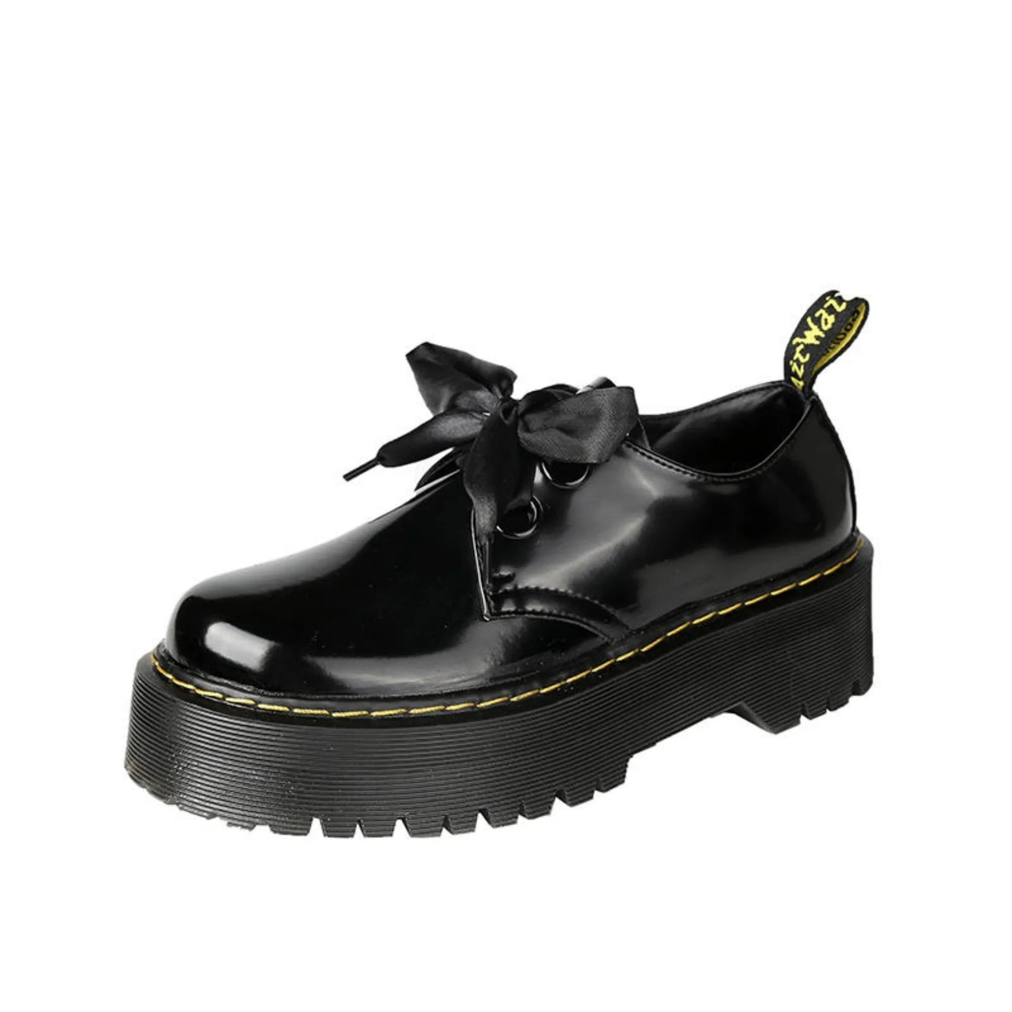 Women's black leather lace-up shoes with thick soles and cross-strap ribbons on the upper.