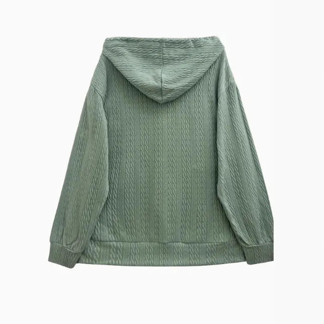 Green hooded zip-front sweatshirt coat on a hanger, showing loose fit and casual style.