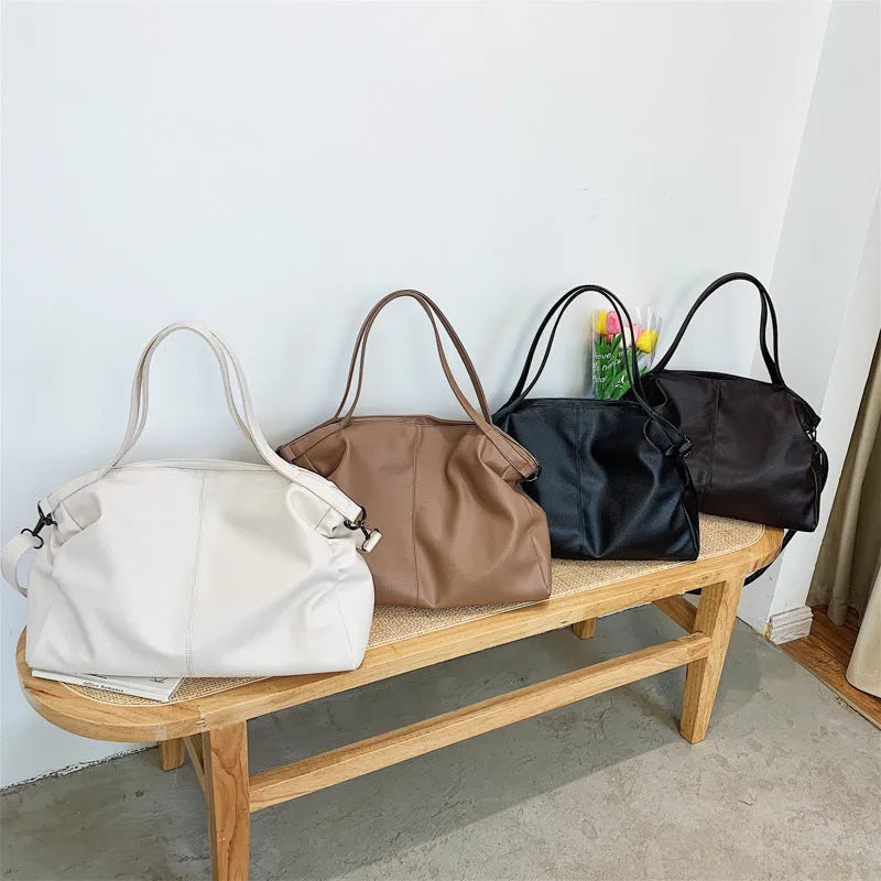 Large soft surface PU messenger tote bag in a horizontal square shape with a zip top and long shoulder strap.