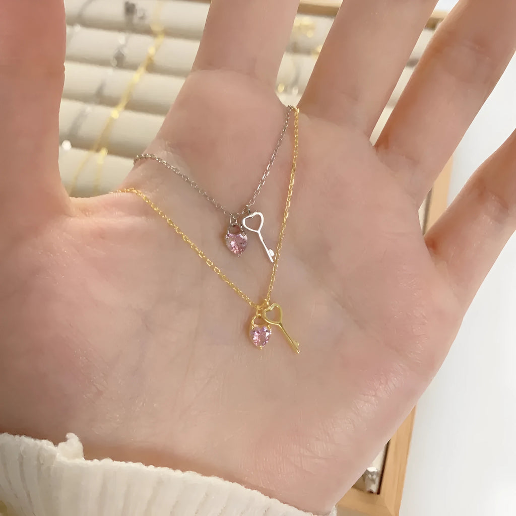 925 sterling silver heart-shaped key pendant necklace in gold finish on display