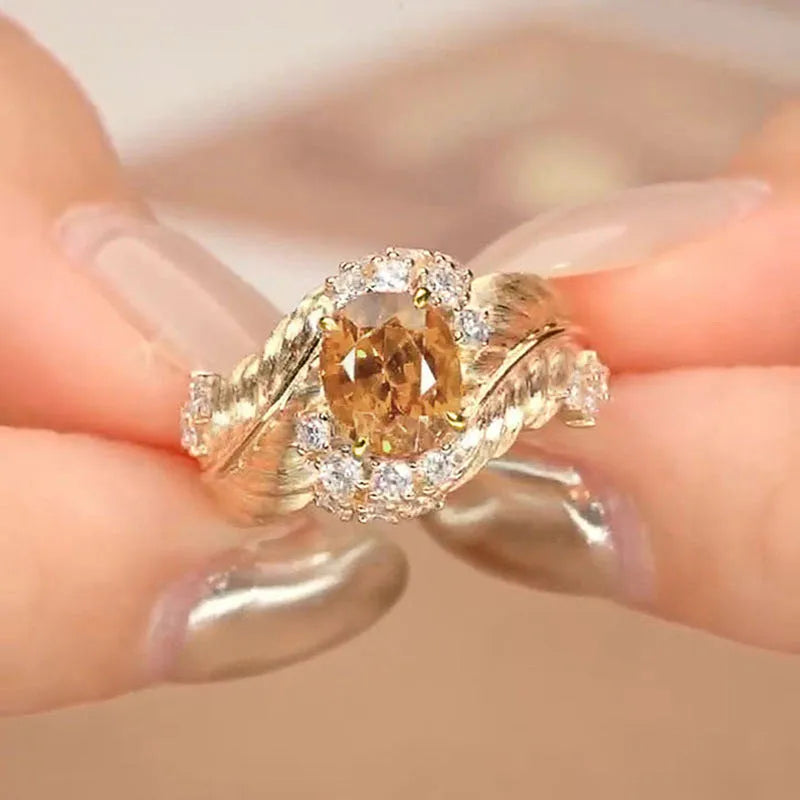 Embossed feather pattern gold ring with yellow zircon stone in geometric setting