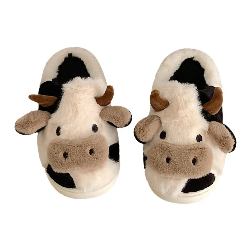 White and coffee coloured cow animal slippers for women with a plush exterior and non-slip sole.