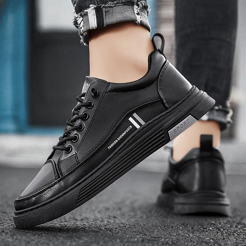 Men's low-top skate shoes in black with microfiber upper, rubber sole, and elastic band.