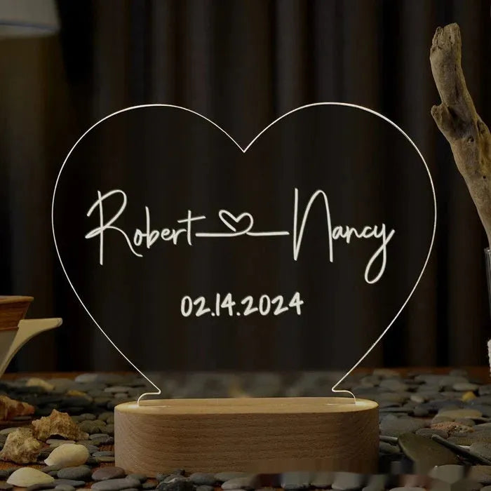 Custom engraved acrylic night light displaying personal names and a date, lit from a base LED.