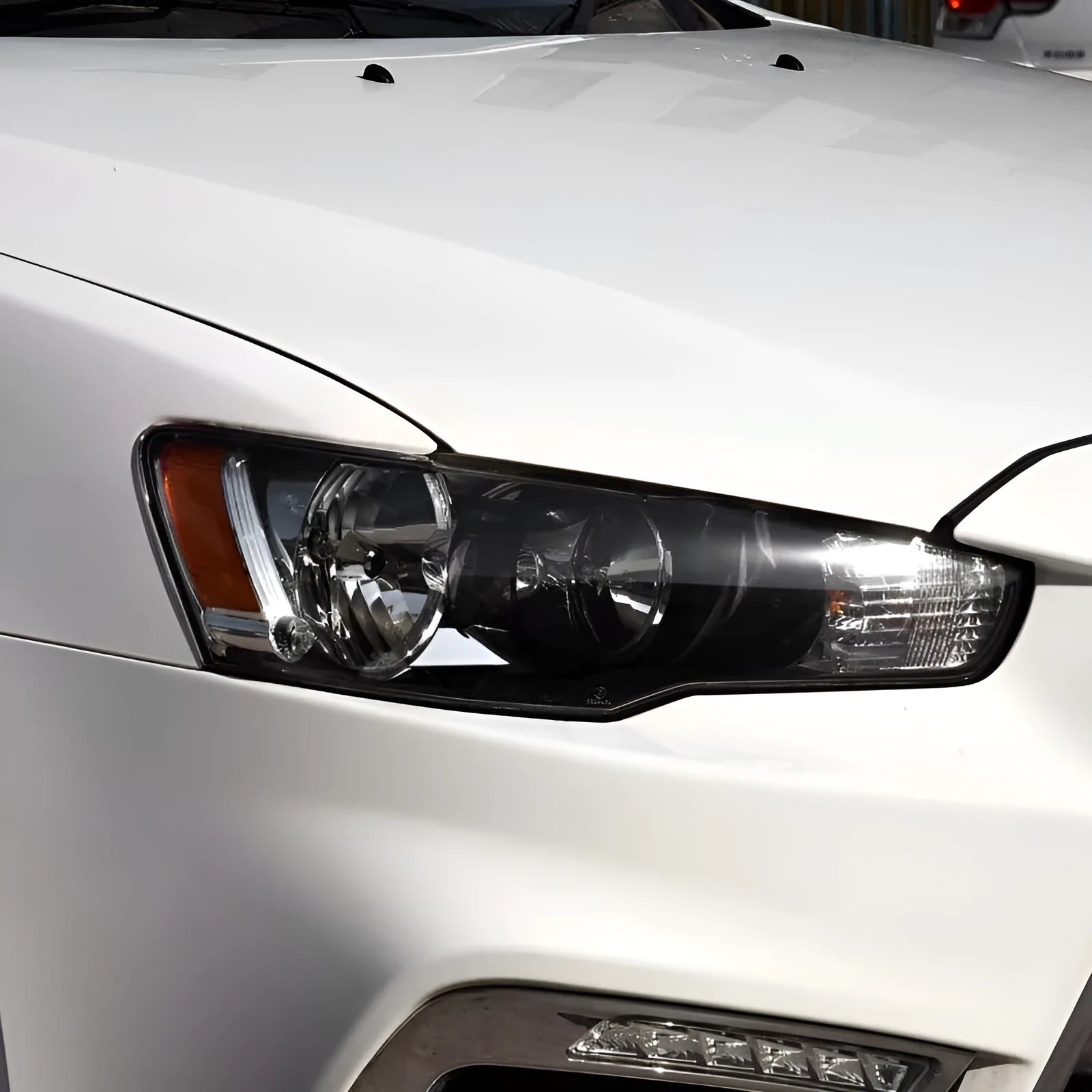 Clear plastic car headlight housing cover with dimensions 50mm by 30mm by 20mm.