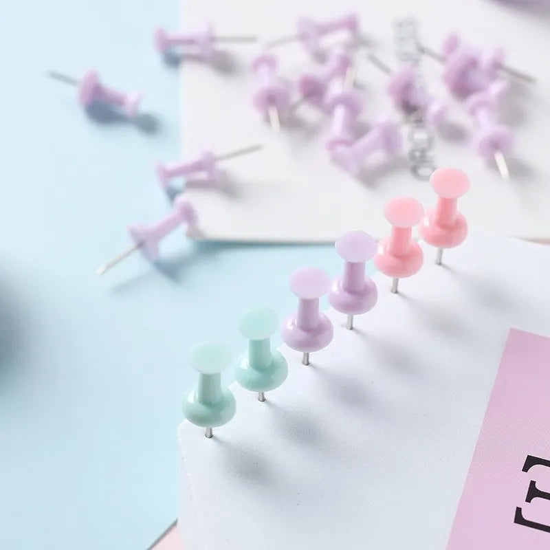 Assortment of plastic push pins in cherry blossom pink, mint green, and lavender, showing large and small sizes.