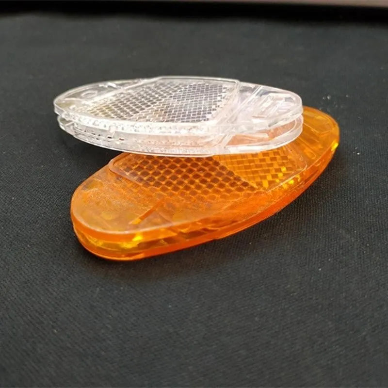 White and yellow plastic bicycle spoke reflectors with reflective warning film