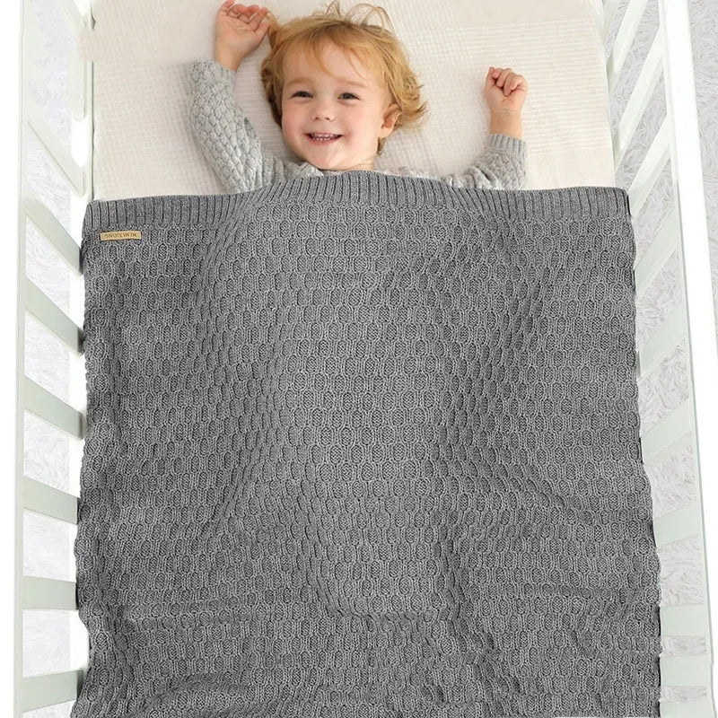 Solid colour infant hug blanket with textured lines, shown in a light green colour.