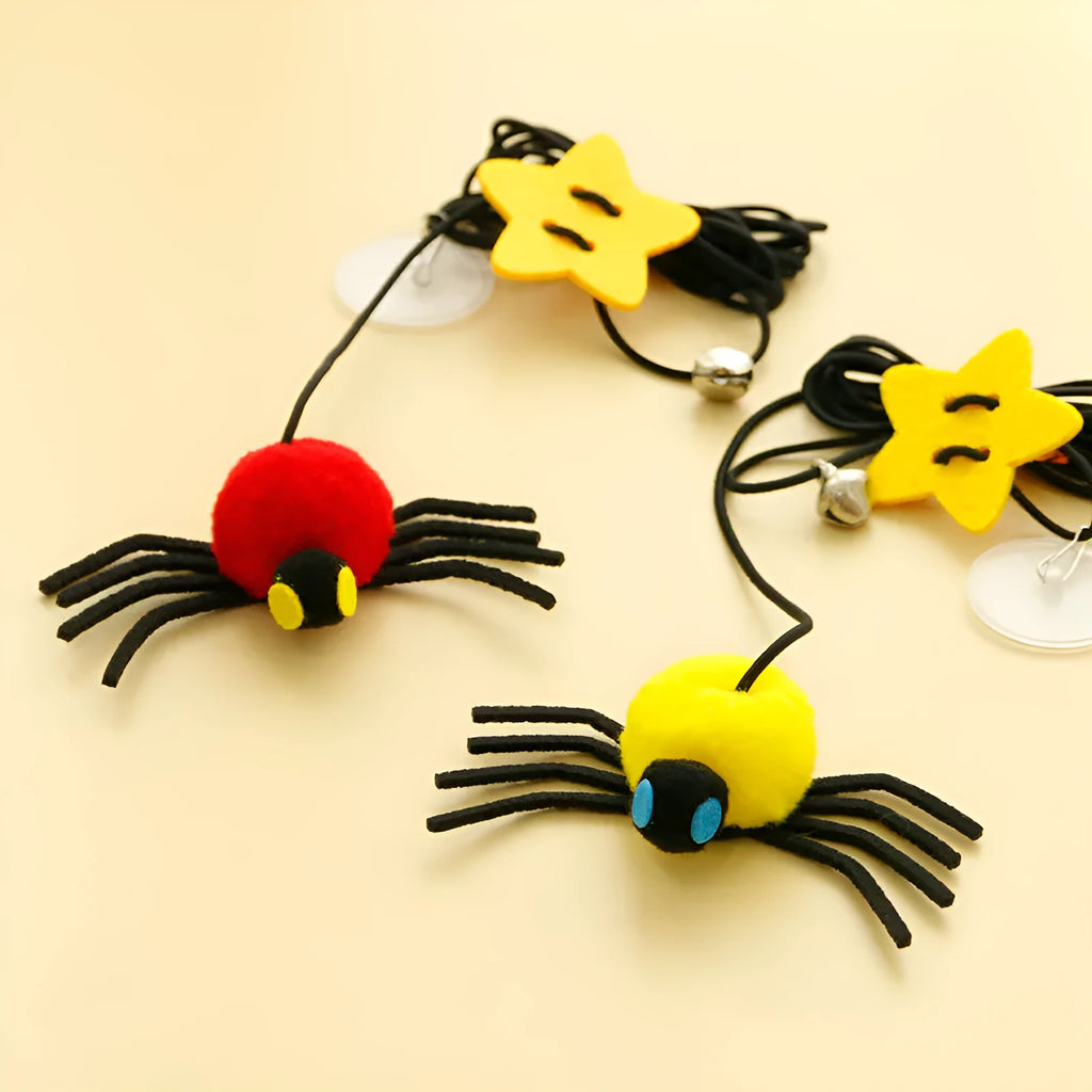 Red and yellow cat door toy with elastic rope, feather, bell, and spider dangling for interactive play.