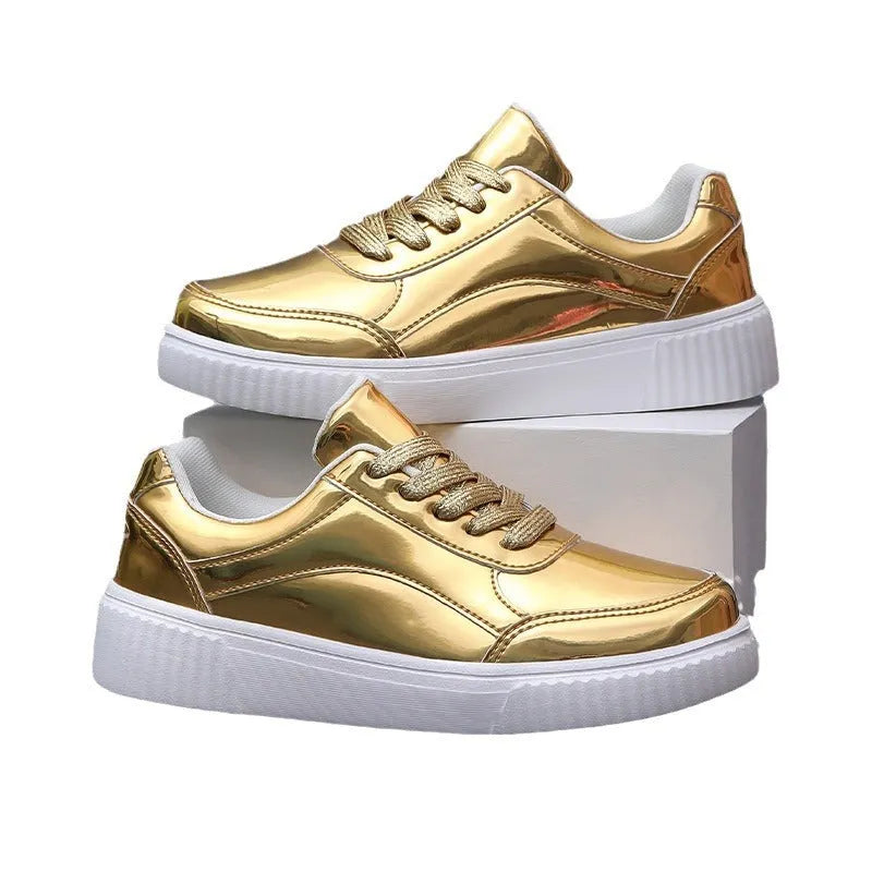 Gold sequinned platform sneakers with thick sole and round toe on a neutral background.