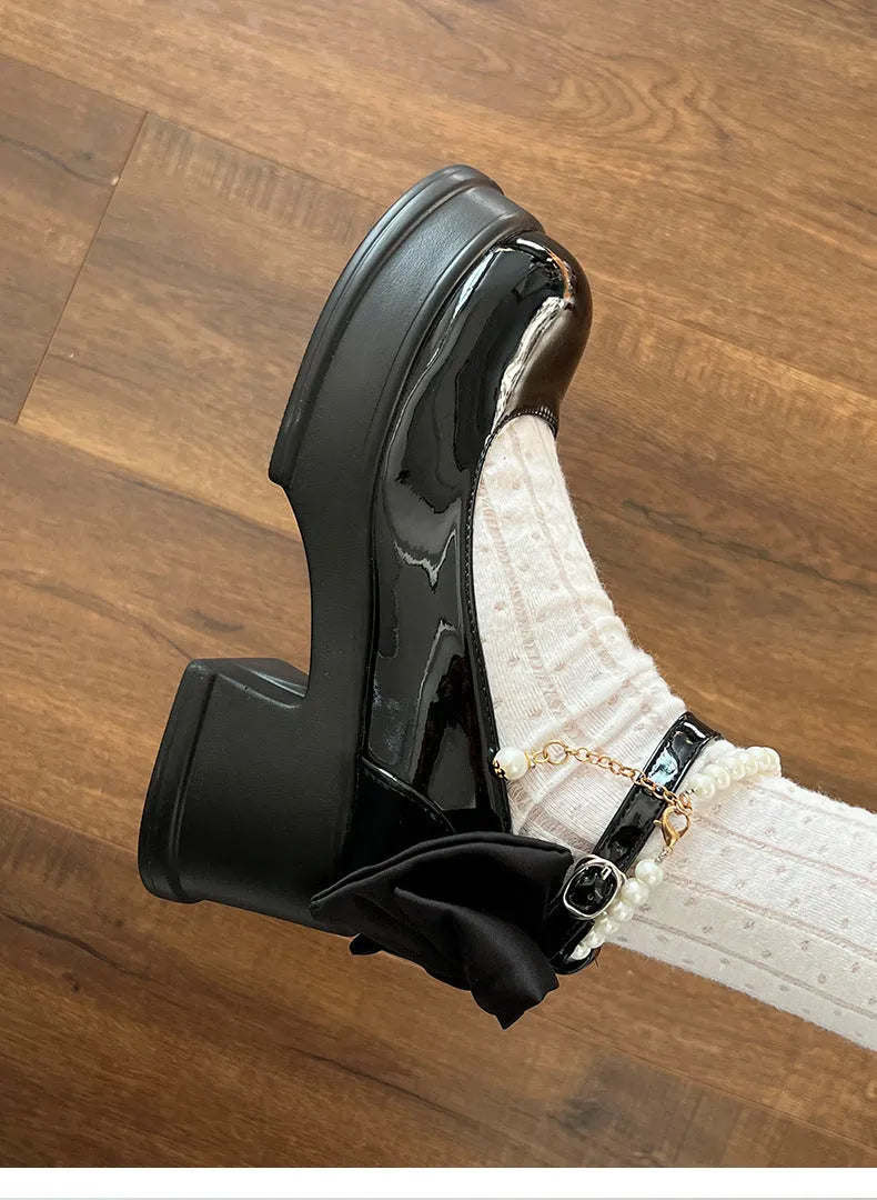 Women's black Mary Jane shoes with chunky 6cm heel and rounded toe, showing strap detail